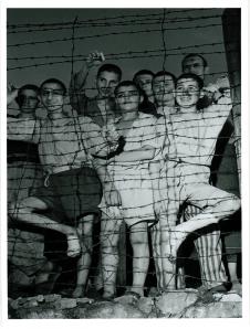 Junge Gefangene des KZ am Stacheldrahtzaun